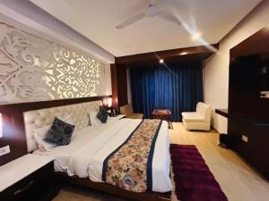 a bedroom with a large bed and a blue curtain at mayur Mora in Rāmgarh +10 photos