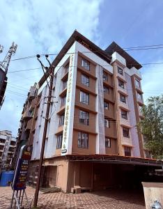 a tall building with a sign on the side of it at Hotel Classic Badlapur - Premium Couple Friendly Hotels in Badlapur in Badlapur