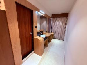 a bathroom with a toilet and a sink and a door at Hotel Classic Badlapur - Premium Couple Friendly Hotels in Badlapur in Badlapur