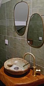 a bathroom with a sink and a mirror at A Toca, Complete townhouse apartment in Monchique +8 photos