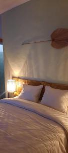 a bed with white sheets and pillows in a bedroom at A Toca, Complete townhouse apartment in Monchique