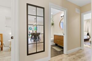 a hallway with a mirror and a dining room at Spruce Suite Historic NOTL - VINEYARD RETREAT in Niagara-on-the-Lake