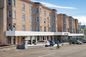 a person riding a bike in front of a building at The Beresford Hotel in Newquay