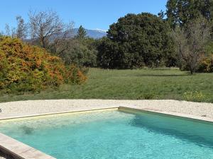 a swimming pool in the middle of a field at le mas au pied du Ventoux in Carpentras