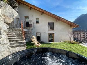 a house with a hot tub in the yard at Al Crotto in Chiavenna