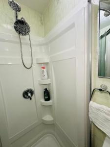 a white bathroom with a shower and a sink at Cozy Private Apartment with 2 Queen size Beds in Moncton +21 photos