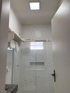 a bathroom with a shower with a glass door at Studio J&C in Primavera do Leste