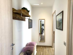 a hallway with a chair and a mirror at Intera casa con due appartamenti indipendenti e vasca idromassaggio a Barbaresco, Langhe in Barbaresco +63 photos
