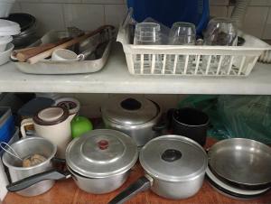 a bunch of pots and pans on a shelf in a kitchen at Refúgio da Aldeia - trabalho ou lazer! in São Pedro da Aldeia