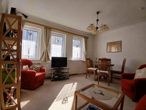 a living room with a red couch and a table at Ferienhaus-Juliana in Stolberg