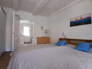 a bedroom with a large white bed with blue pillows at Ferienhaus-Juliana in Stolberg