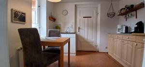 a kitchen with a table with a laptop on it at Ferienhaus-Juliana in Stolberg