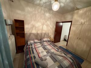 a bedroom with a bed with towels on it at Zoes apartments in Orestiada