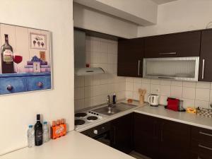 a kitchen with a sink and a stove top oven at Zoes apartments in Orestiada