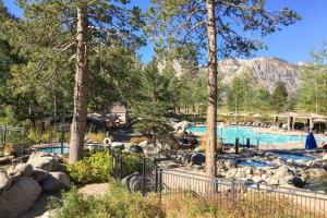 a swimming pool in a resort with trees at Everline Resort Suite: North Lake Tahoe Luxury! in Olympic Valley