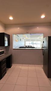 a kitchen with a refrigerator and a window at درة العروس البرادايس دور علوي عوائل فقط in Durat Alarous