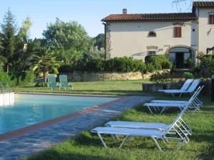 a couple of lounge chairs next to a swimming pool at Agriturismo Villani Poderi Nesti & Cupoli in Lastra a Signa