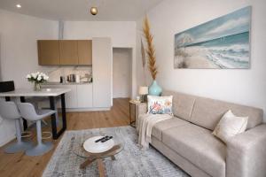 a living room with a couch and a table at Boutique Apartment Trieste in Trieste
