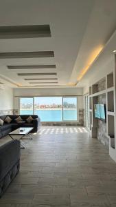 a large living room with a couch and a television at درة العروس البرادايس دور علوي عوائل فقط in Durat Alarous