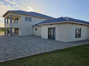 a large white house with a driveway at Blueroof BYO in Bulawayo