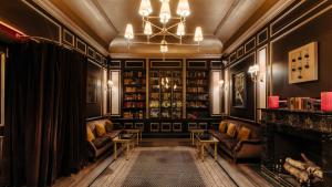 a living room with couches and a fireplace at The William Hotel Midtown, New York in New York