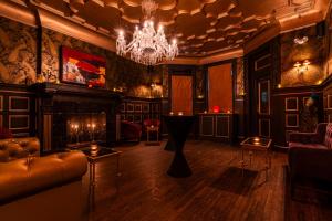 a living room with a chandelier and a couch at The William Hotel Midtown, New York in New York
