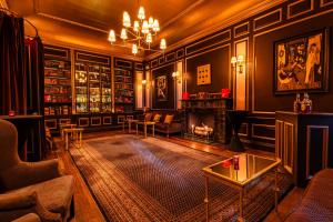 a living room with a fireplace and a table at The William Hotel Midtown, New York in New York