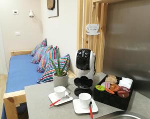 a room with a bed and a table with a coffee maker at La Libellula Rossa in Puos dʼAlpago +14 photos