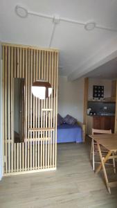 a room with a room with a bed and a table at La Libellula Rossa in Puos dʼAlpago
