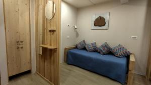 a bedroom with a blue bed with two pillows at La Libellula Rossa in Puos dʼAlpago