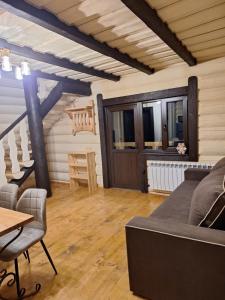 a living room with a couch and a table at Шепіт Карпат 2 in Synevyrsʼka Polyana