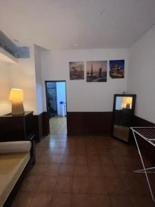 a room with a couch and a lamp on a wall at Tourist Rendez Vous Hotel in Plaine Magnien