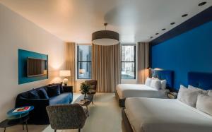 a hotel room with two beds and a couch at The William Hotel Midtown, New York in New York +22 photos