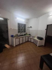 a kitchen with white cabinets and a sink and a counter at Tourist Rendez Vous Hotel in Plaine Magnien