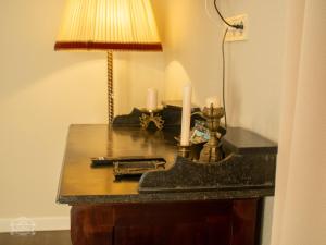 a table with a lamp and candles on it at Casa Kresován in Sarmizegetusa +41 photos