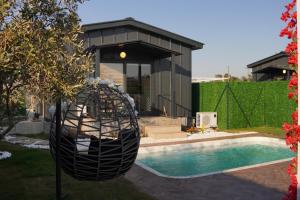 a house with a swimming pool and a black swing at ON2 Bungalov Villas in Dosemealti