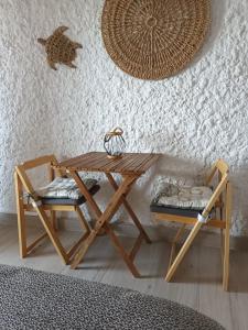 a wooden table and two chairs next to a table at Beautiful sea view studio in Lumio