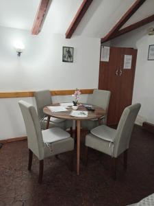 a dining room with a table and chairs at Apartman Kamen 1 in Negotin +17 photos