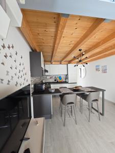 a kitchen with a table and chairs in a room at marinella house 2 in Sarzana