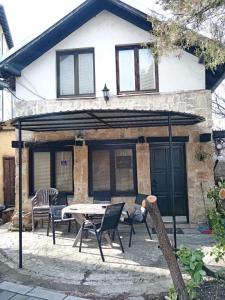 a patio with a table and chairs in front of a house at Apartman Kamen 1 in Negotin
