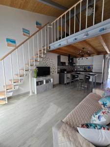 a living room with a couch and a staircase at marinella house 2 in Sarzana +15 photos