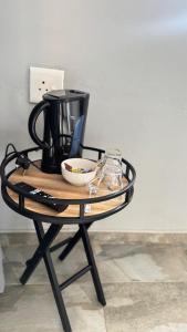 a table with a coffee maker and a bowl on it at Mercy Guesthouse in Thohoyandou