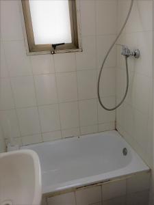 a bathroom with a shower with a white tub at Cabaña a pasos del mar in El Cerrillo
