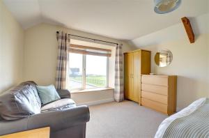 a living room with a couch and a window at 3 Bed in Southerndown oc-way216 in Southerndown
