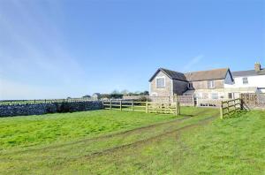 a large field with a house and a fence at 3 Bed in Southerndown oc-way216 in Southerndown