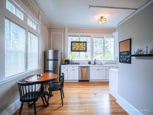 a kitchen with a table and chairs and a refrigerator at Oak and Ember at Marietta Square in Marietta