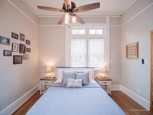 a bedroom with a bed with a ceiling fan at Oak and Ember at Marietta Square in Marietta