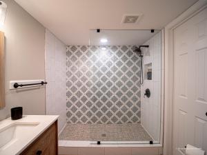 a bathroom with a shower and a sink at Oak and Ember at Marietta Square in Marietta