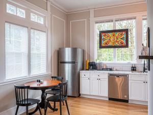 a kitchen with a table and a refrigerator at Oak and Ember at Marietta Square in Marietta +20 photos