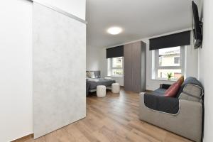 a living room with a couch and a tv at Mondeo B&B in Udine